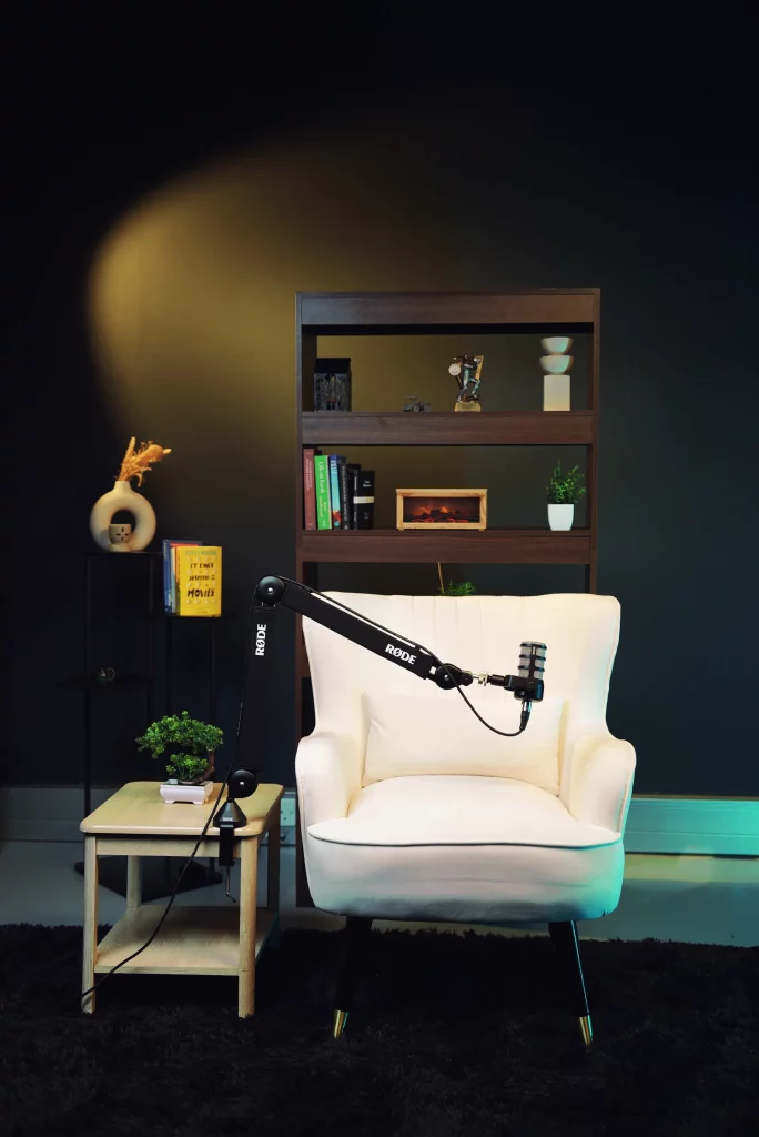 Professional recording setup featuring a Rode boom arm and guest seating for podcast studio hire.